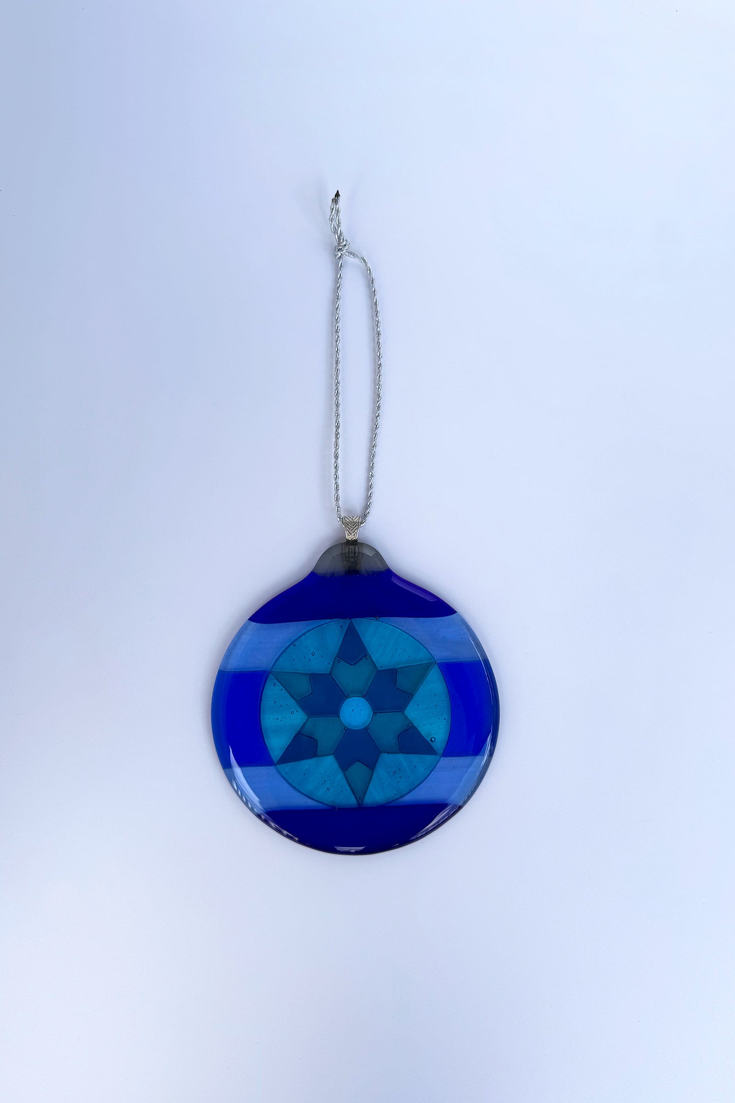 Blue 6-Point Star Fused Glass Ornament by AWinburnART varying shades of blue from cobalt to teal blue glass with sterling silver-plated bail.