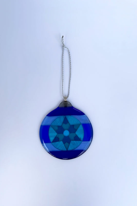 Blue 6-Point Star Fused Glass Ornament by AWinburnART varying shades of blue from cobalt to teal blue glass with sterling silver-plated bail.