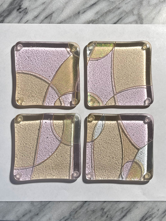 Celebrate! set of four handcrafted fused glass coasters in blush and champagne pink, displayed on marble, by Angie of AWinburnART