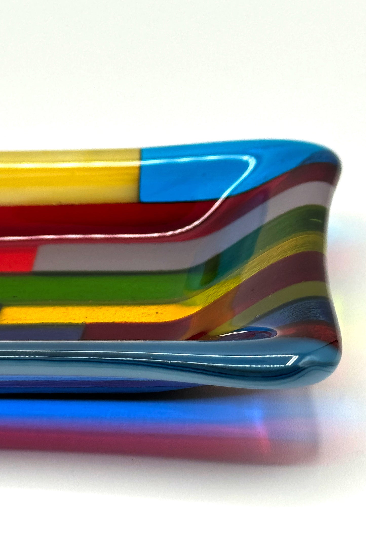 Blue dominant multicolor hard-edge fused glass dish by AWinburnART, side detail view